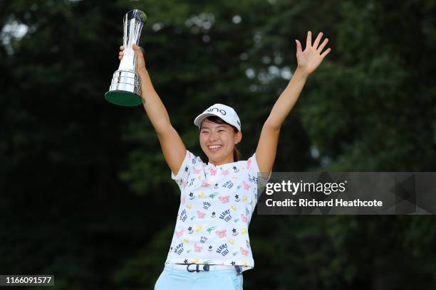 Hinako Shibuno of Japan celebrates victory with the trophy during the final round of the AIG Women's British Open at Woburn Golf Club on August 04,...