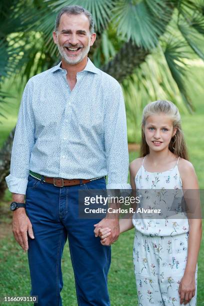 King Felipe VI of Spain and Princess Leonor of Spain pose for the photographers during the summer photocall at the Marivent Palace on August 04, 2019...