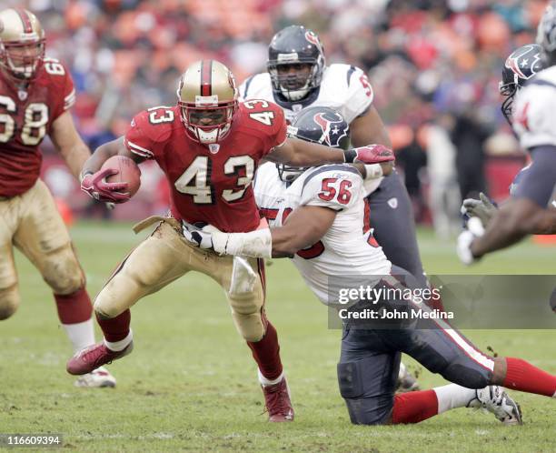 San Francisco running back Maurice Hicks is tackled by Houston linebacker Morlon Greenwood during the 49ers 20-17 overtime defeat of the Houston...