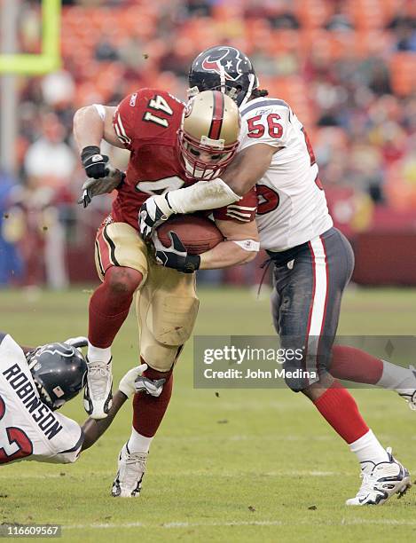San Francisco fullback Chris Hetherington is tackled by Houston linebacker Morlon Greenwood during the 49ers 20-17 overtime defeat of the Houston...