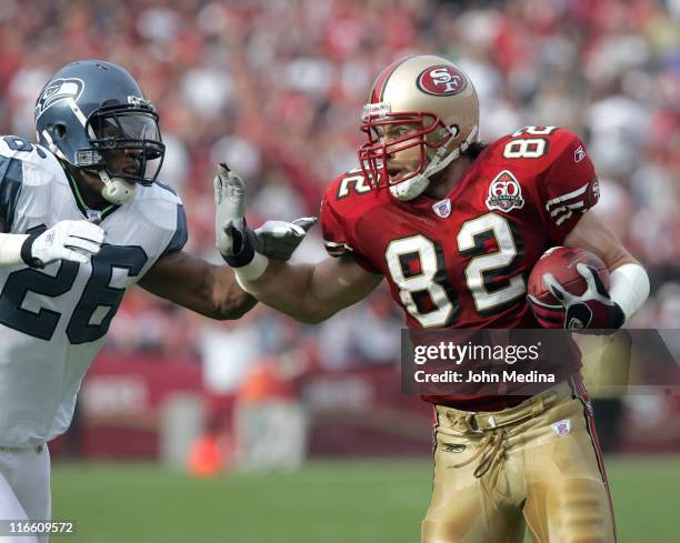 49ers tight end Eric Johnson tries to avoid being tackled by a Seahawk during the San Francisco 49ers 20-14 defeat of the Seattle Seahawks November...