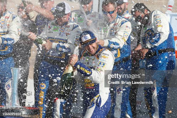 Chase Elliott, driver of the NAPA AUTO PARTS Chevrolet, celebrates with crew members in Victory Lane after winning the Monster Energy NASCAR Cup...