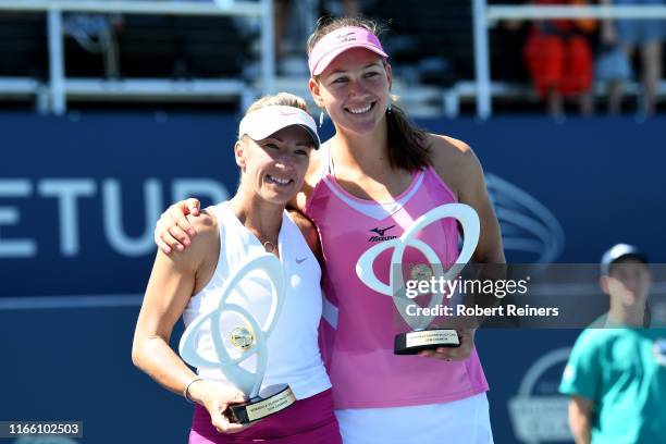 Nicole Melichar of United States and Kveta Peschke of Czech Republic celebrate with their trophies after defeating Shuko Aoyama of Japan and Ena...