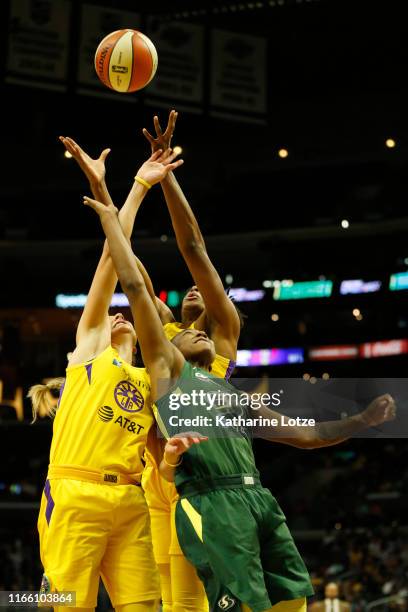 Sydney Wiese of the Los Angeles Sparks, Nneka Ogwumike of the Los Angeles Sparks and Jewell Loyd of the Seattle Storm reach for a rebound during the...