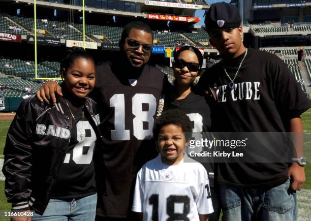 Ice Cube aka O'Shea Jackson poses with family in an Oakland Raiders No. 18 Randy Moss jersey before game against the Dallas Cowboys at McAfee...