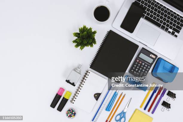 top view of laptop, notebook, coffee and office supply items on white desk - knolling tools stock pictures, royalty-free photos & images