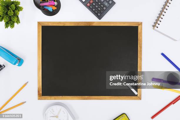 blackboard and school supply items on white desk - chalkboard eraser stock pictures, royalty-free photos & images