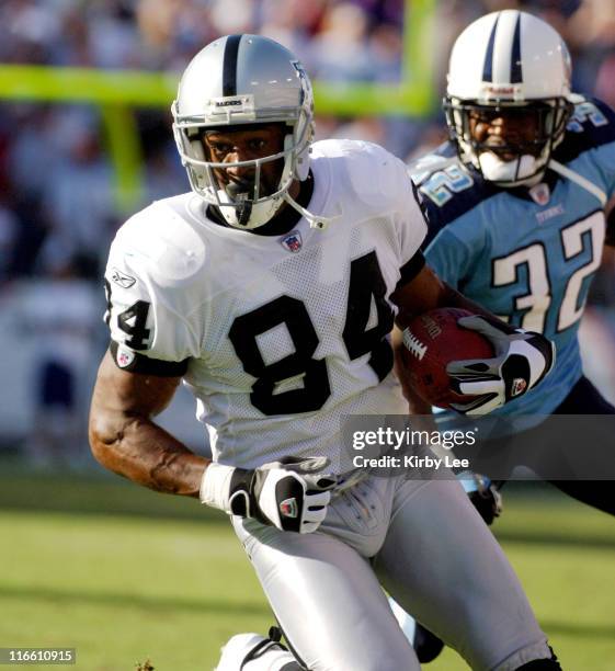 Oakland Raiders receiver Jerry Porter heads up field on a 44-yard touchdown pass as Pacman Jones of the Tennessee Titans give chase in the fourth...