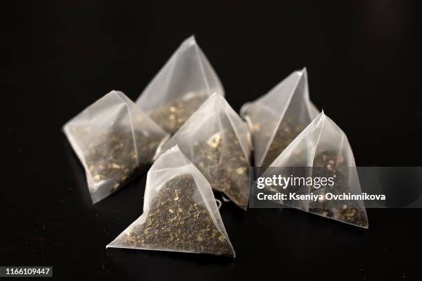 the tea bags isolated on black. - ティーバッグ ストックフォトと画像