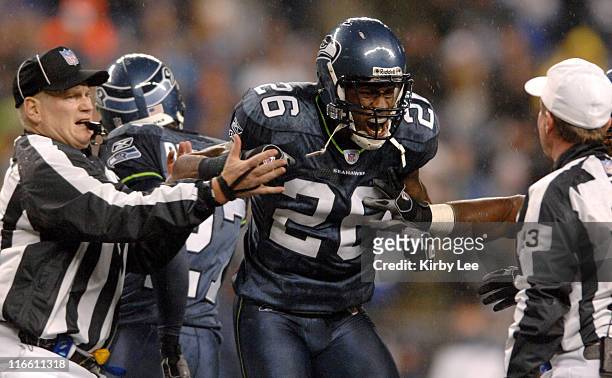 Seattle Seahawks cornerback Ken Hamlin is restrained by umpire Bill Schuster, left, while arguing with referee Bill Carollo during ESPN Monday Night...