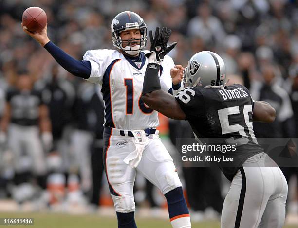 Denver Broncos quarterback Jake Plummer passes under pressure from Derrick Burgess of the Oakland Raiders at McAfee Coliseum in Oakland, Calif. On...