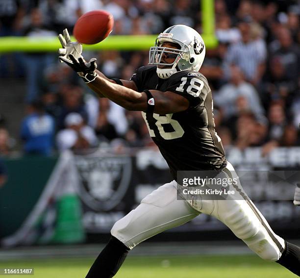 Oakland Raiders receiver Randy Moss stretches for a fingertip catch during 31-17 loss to the Denver Broncos at McAfee Coliseum in Oakland, Calif. On...