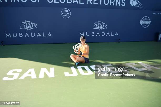 Saisai Zheng of China celebrates with the winner's trophy after defeating Aryna Sabalenka of Belarus in the singles final of the Mubadala Silicon...