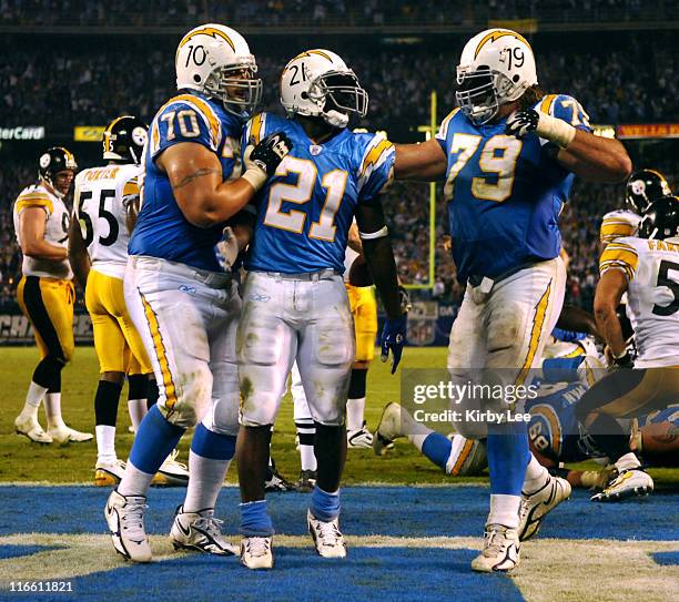 San Diego Chargers running back LaDainian Tomlinson is congratulated by offensive tackle Shane Olivea and offensive guard Mike Goff after scoring on...