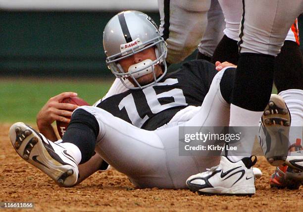 Oakland Raiders quarterback Andrew Walter sits on the ground after being sacked during 24-21 loss to the Cleveland Browns at McAfee Coliseum in...