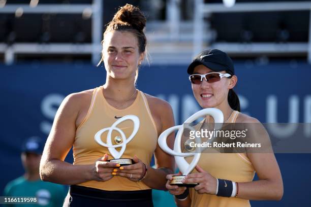 Saisai Zheng of China and Aryna Sabalenka of Belarus pose with their trophies following the singles final of the Mubadala Silicon Valley Classic at...