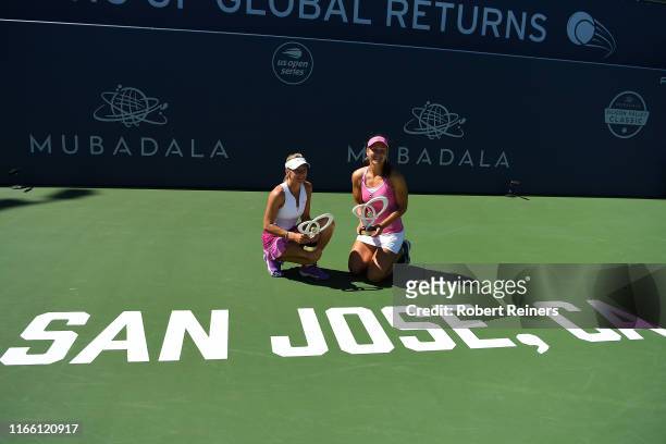 Nicole Melichar of United States and Kveta Peschke of Czech Republic celebrate with their trophies after defeating Shuko Aoyama of Japan and Ena...