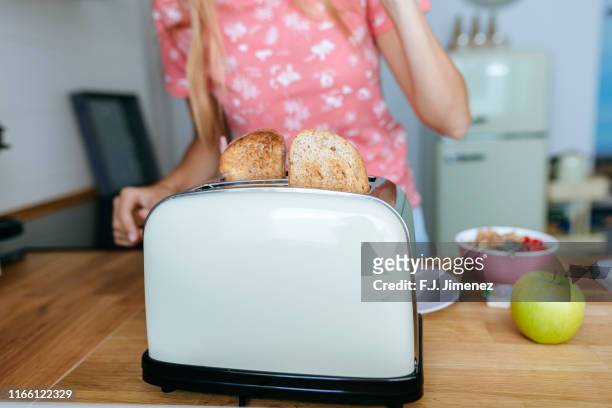 toasted bread close-up in the toaster - toaster fotografías e imágenes de stock