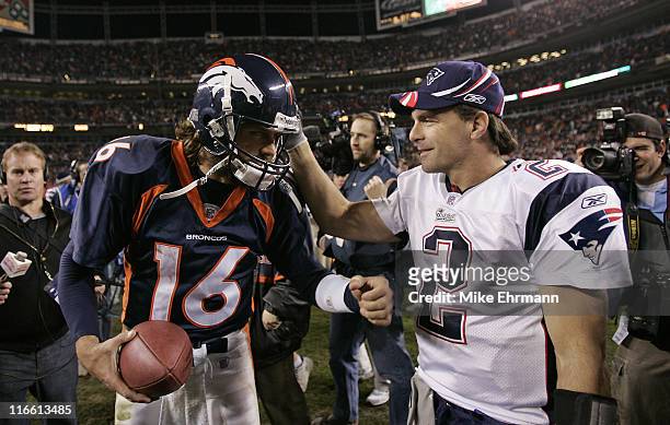 Quarterback Jake Plummer of the Denver Broncos is congratulated by Doug Flutie after the AFC Divisional Playoff game against the New England Patriots...