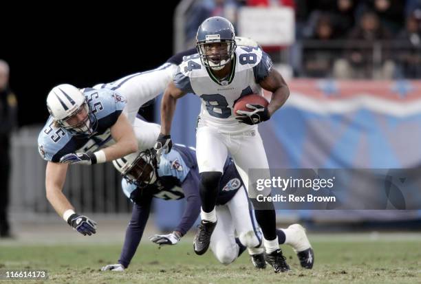 Tennesse's Brad Kassell and teammate Reynaldo Hill can't reach Seattle's Bobby Engram as he picks up a first down against the Titans December 18 at...