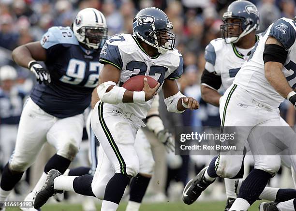 Seattle's Shaun Alexander works to pick up yardage against the Titans December 18 at the Coliseum, in Nashville, Tennessee. Seattle defeated...