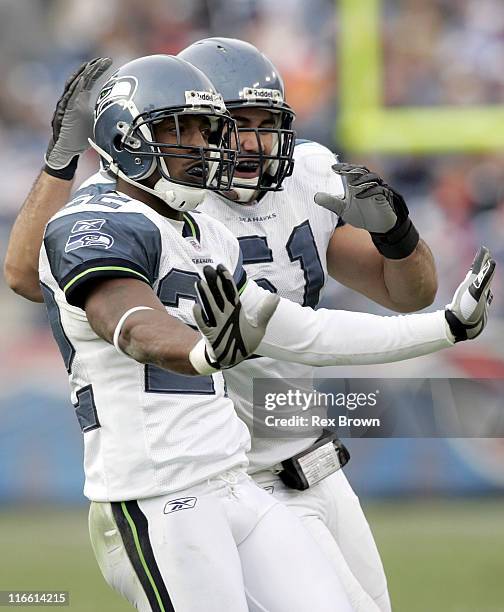 Seattle's Jimmy Williams is congratulated by teammate Lafo Tatupu after breaking up a pass during the second half December 18 at the Coliseum, in...
