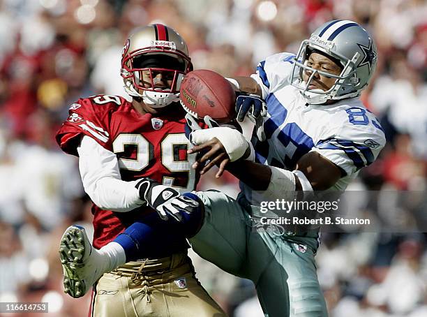 Cowboys receiver Terry Glenn and 49ers cornerback Ahmed Plummer fight over a ball in the second half as the Dallas Cowboys defeated the San Francisco...