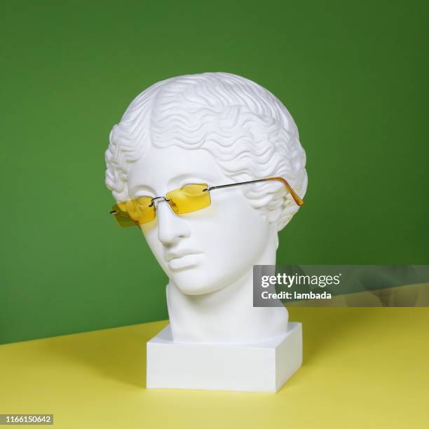 plaster head with yellow sunglasses - yellow sunglasses stock pictures, royalty-free photos & images