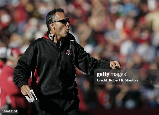 49ers head coach Mike Nolan signals to his team on the field during second half action as the San Francisco 49ers defeated the Tampa Bay Buccaneers...