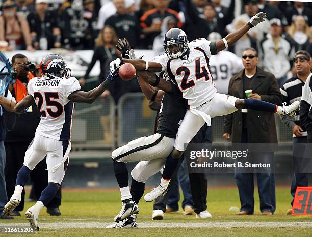 Broncos corner Champ Bailey and safety Nick Ferfuson break up a pass to Oakland receiver Randy Moss as the Denver Broncos defeated the Oakland...