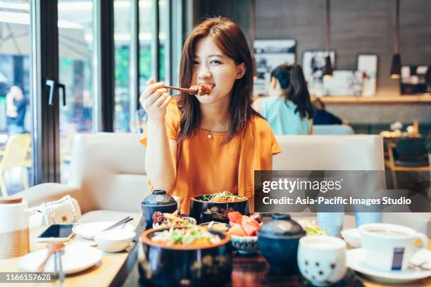 junge asiatische frau genießen japanischen essen-aal-reis. - aalen stock-fotos und bilder