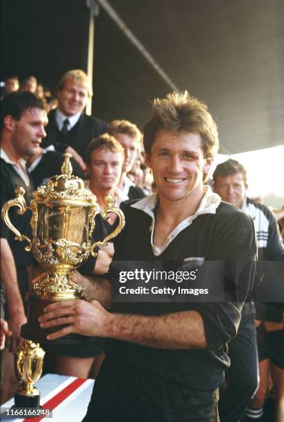 David Kirk, captain of the New Zealand All Blacks, holding the Webb Ellis trophy after winning the inaugural Rugby Union World Cup Final against...