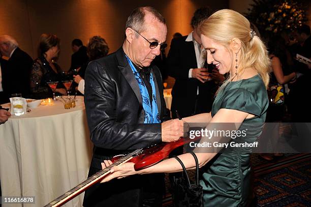 Songwriter Bernie Taupin signs a guitar at the Songwriters Hall of Fame 42nd Annual Induction and Awards at The New York Marriott Marquis Hotel -...