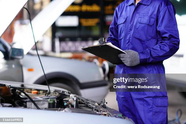 automotive mechanic doing vehicle maintenance checklist - car inspection stock pictures, royalty-free photos & images