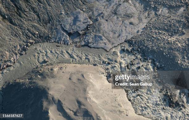 In this view from an airplane meltwater rushes down from the Greenland ice sheet near Sermeq Avangnardleq glacier on August 04, 2019 near Ilulissat,...