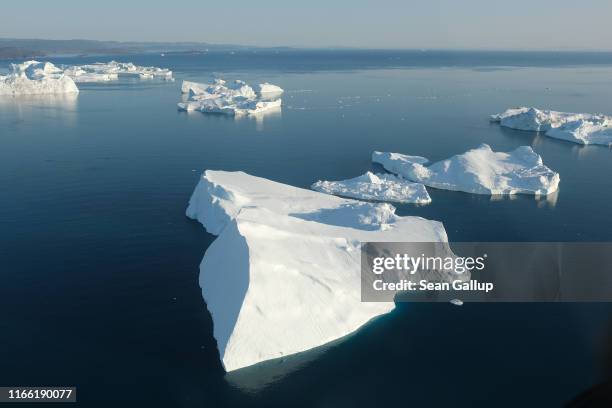 In this view from an airplane icebergs float at the mouth of the Ilulissat Icefjord on August 04, 2019 near Ilulissat, Greenland. The Sahara heat...