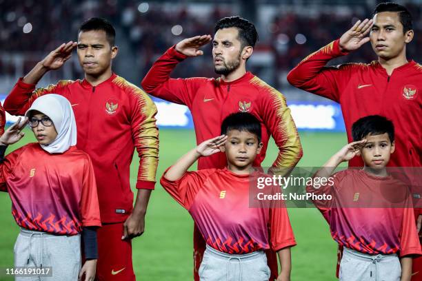 Indonesian's Manahati Lestusen, Stefano Lilipaly and Ricky Fajrin Saputra sing National Anthem during FIFA World Cup 2022 qualifying match between...