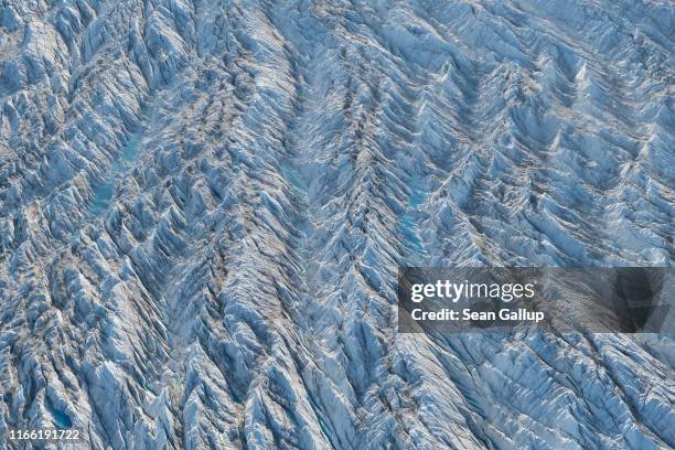 In this view from an airplane ice forms a ridged landscape on the Sermeq Kujalleq glacier, also called the Jakobshavn glacier, on August 04, 2019...