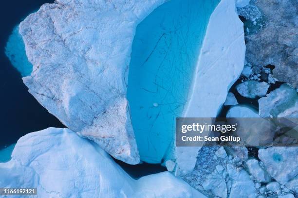 In this aerial view meltwater forms a lake on an iceberg in the Ilulissat Icefjord on August 04, 2019 near Ilulissat, Greenland. The Sahara heat wave...