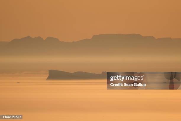 An iceberg floats in Disko Bay at sunset on August 04, 2019 near Ilulissat, Greenland. The Sahara heat wave that recently sent temperatures to record...