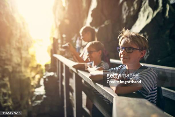 family exploring caves in campania, italy - grotto cave stock pictures, royalty-free photos & images