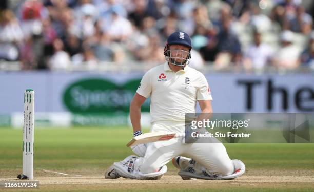 England batsman Jonny Bairstow reacts as the ball goes through off his glove to be caught by Cameron Bancroft during the fifth day of the 1st Test...