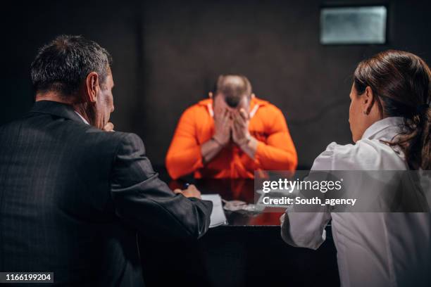 detectives interrogating a man prisoner - confession law stock pictures, royalty-free photos & images