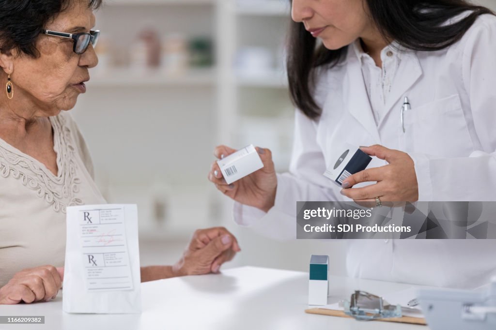 Senior woman receives multiple prescriptions at pharmacy