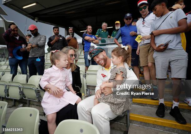 David Warner of Australia celebrates with his wife Candice Warner and daughters Indi and Ivy after day five of the 1st Specsavers Ashes Test between...