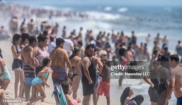 Crowds of people enjoy the sand and surf at Jones Beach in Wantagh, New York on July 20, 2019.