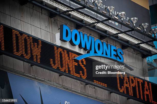 The words "Dow Jones" are displayed on the Dow Jones news ticker in Times Square in New York, U.S., on Thursday, June 16, 2011. The Bloomberg via...