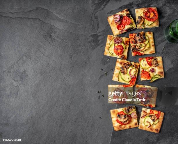 vegetarian flatbread pizza on black background - flatbread pizza stock pictures, royalty-free photos & images