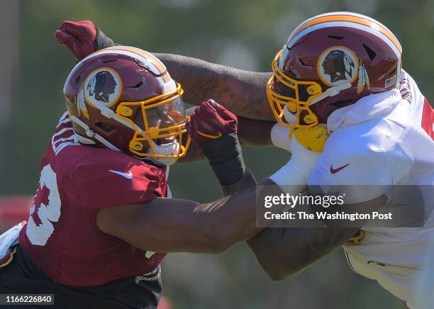 Washington Redskins defensive end Jonathan Allen , left, and Washington Redskins offensive tackle Morgan Moses face off during day 4 of summer...