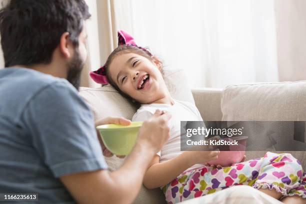father and daughter having cereals for breakfast - kidstock girl stock pictures, royalty-free photos & images